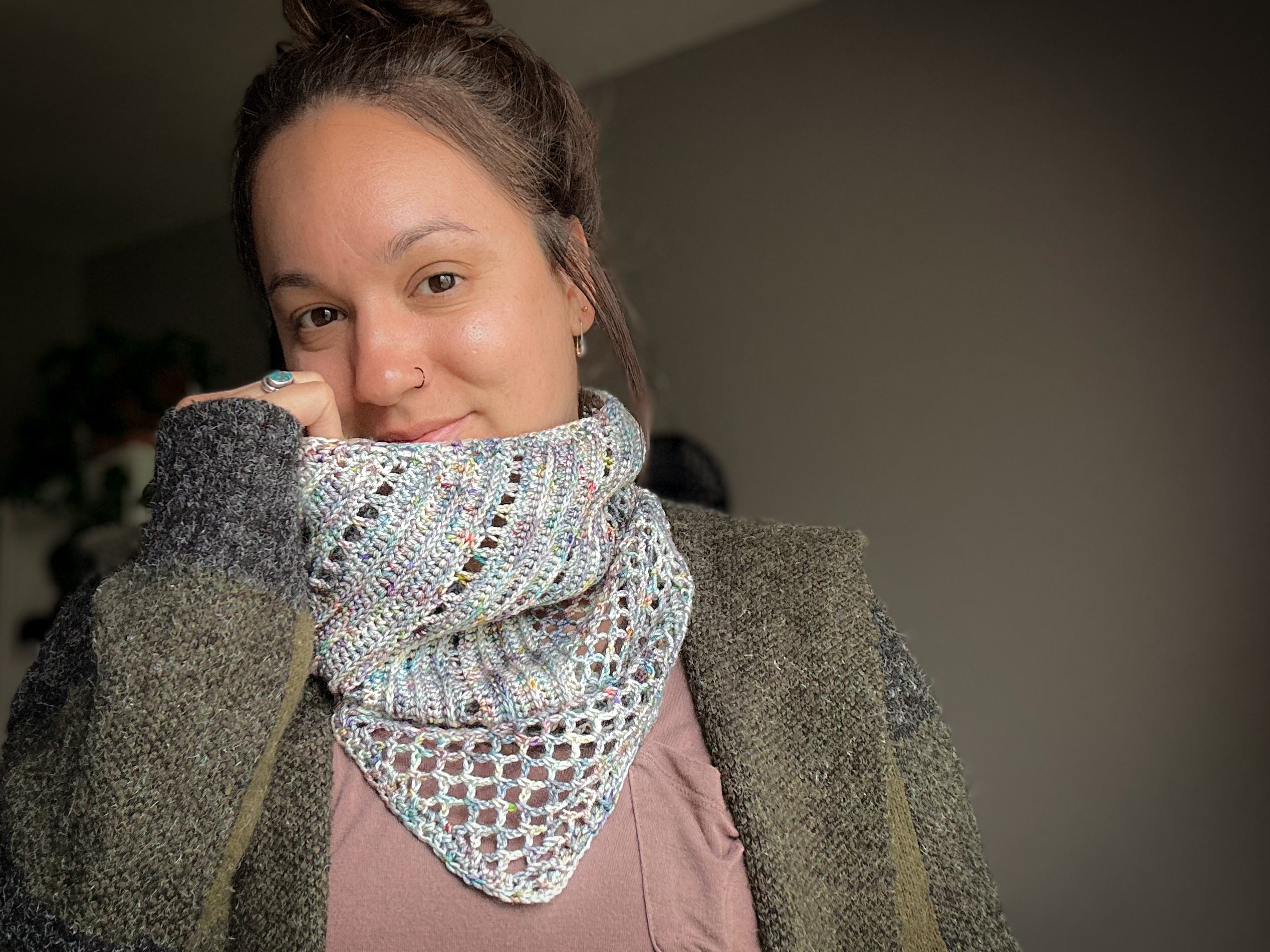 Woman wearing a patterned scarf with a neutral background