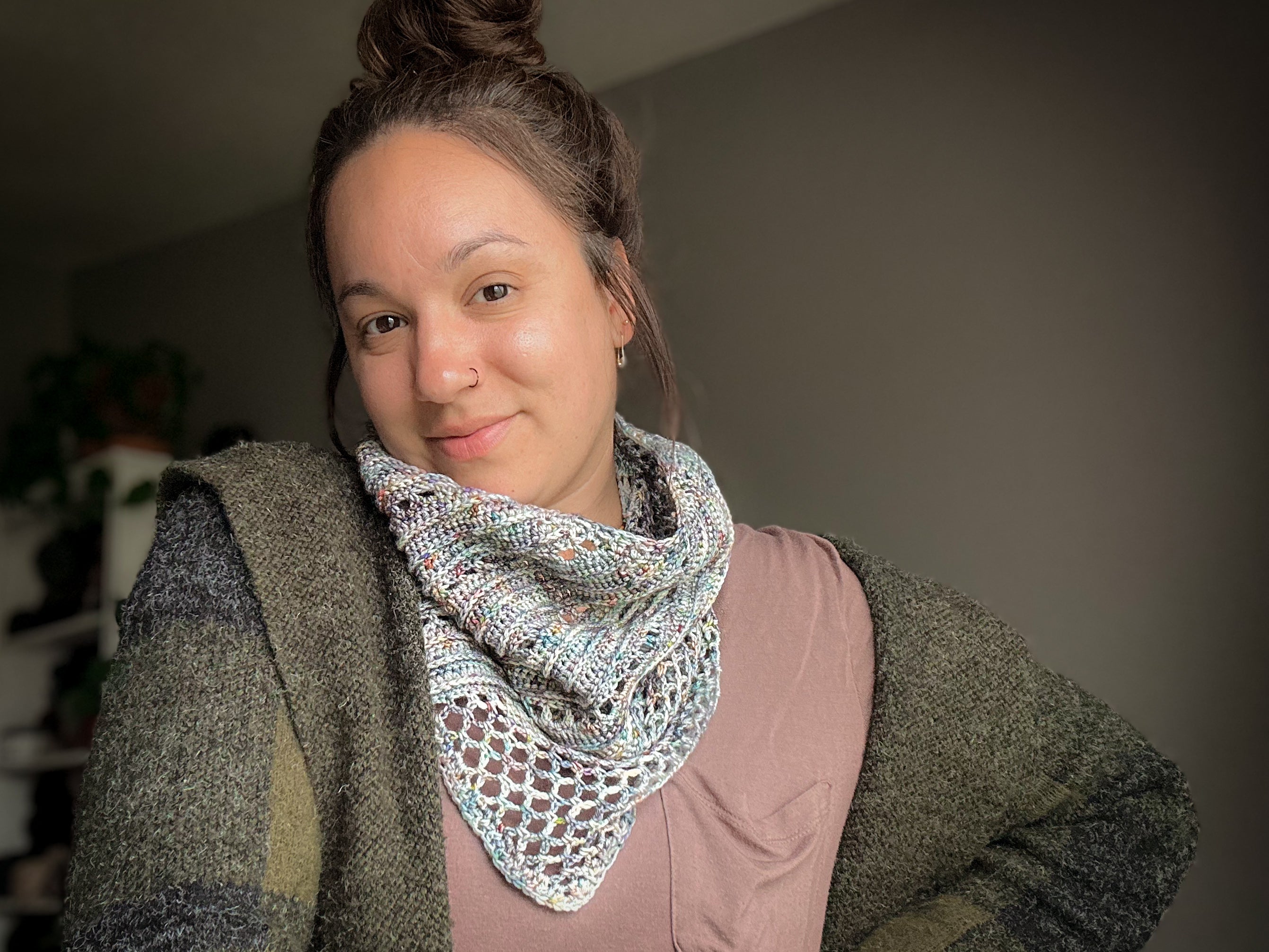 Woman wearing a patterned scarf with a neutral background